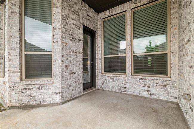 Entrance to property with brick siding and a patio | Image 15