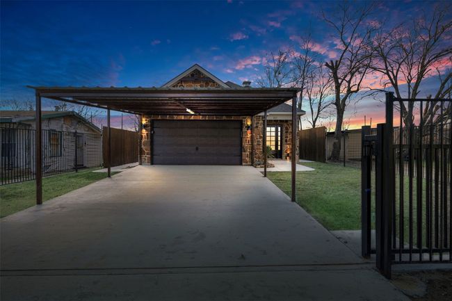 View of front of property featuring a carport, a garage, and a lawn | Image 4