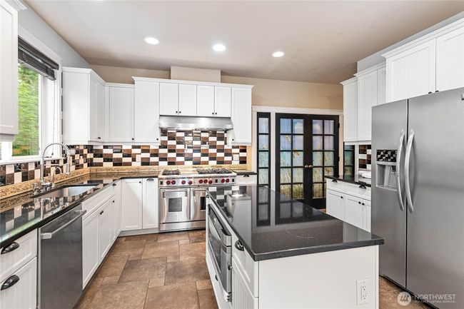 The island has a built-in microwave, additional storage, and plenty of prep space. | Image 5