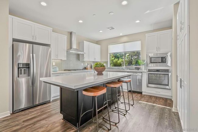 Gorgeous designer kitchen with plenty of counter space and top of the line appliances | Image 13