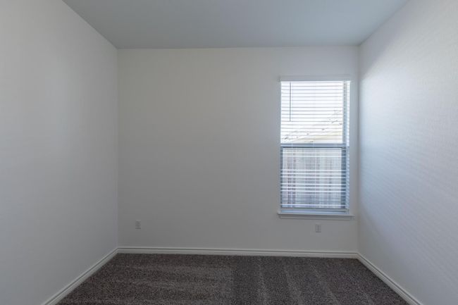 Unfurnished room with baseboards and dark carpet | Image 26