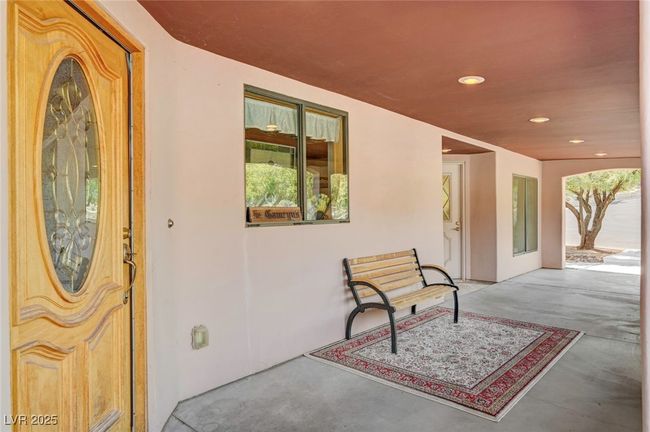 Entrance to property featuring stucco siding and a patio | Image 10