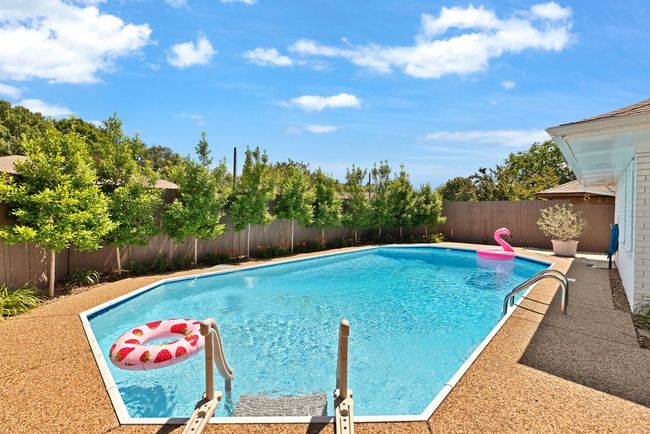 View of swimming pool featuring a fenced backyard | Image 31