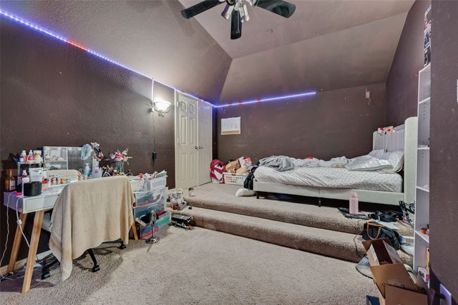 Bedroom with carpet flooring, vaulted ceiling, and ceiling fan | Image 20