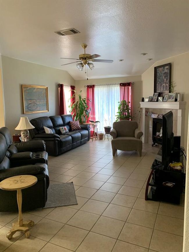 Large family living area with a fireplace. | Image 10
