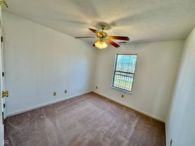 unfurnished room featuring visible vents, a ceiling fan, a textured ceiling, carpet, and baseboards | Image 9