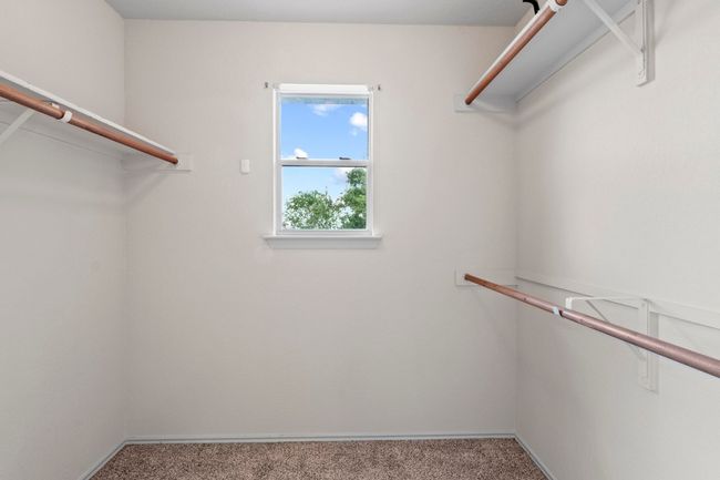 The walk-in closet has a window and space for your wardrobe. | Image 20