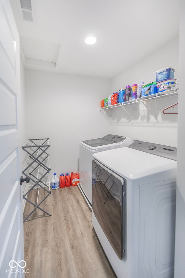 Upstairs laundry area featuring washing machine and dryer | Image 15