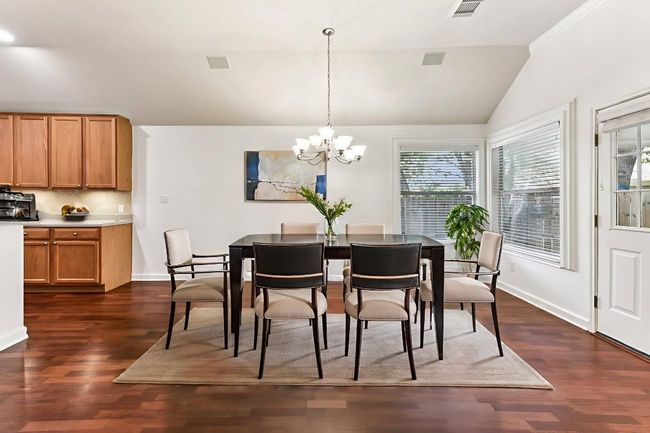 Virtually staged dining are open to kitchen and family room | Image 21