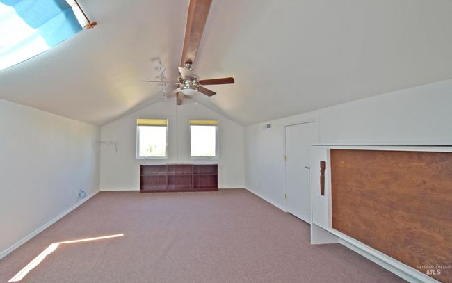3/4 Bath in Upstairs Bedroom. Skylight opens and can access the roof to take in the view. A void in the wall to the left could provide more space for a play area or fort if opened up. | Image 26