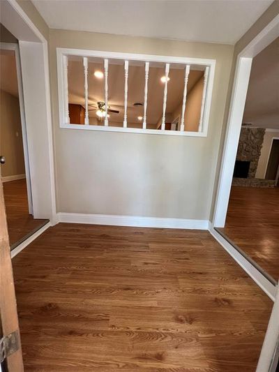 Unfurnished room with a fireplace and hardwood / wood-style floors | Image 2