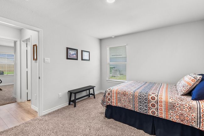 Bedroom with light carpet and light wood finished floors | Image 31