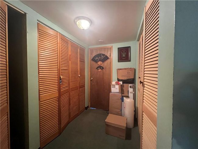 Storage room with many closets w/ bifold doors | Image 19