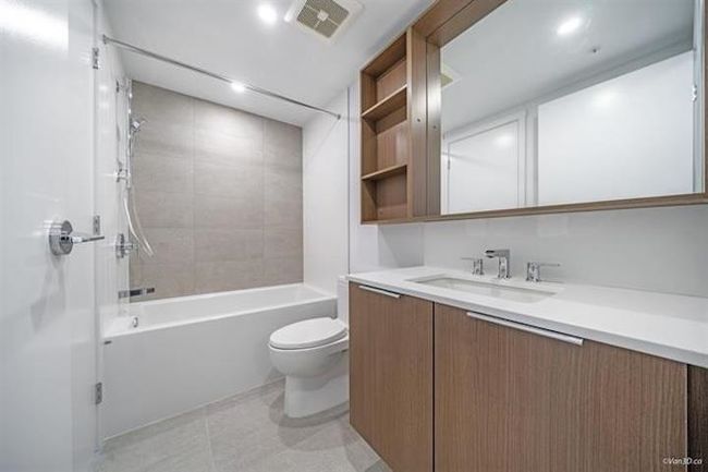 Bathroom with vanity, shower / washtub combination, and tile patterned flooring | Image 11