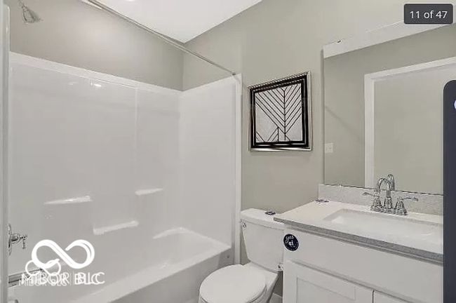 Upstairs full bathroom featuring double vanity, toilet, and shower / bathtub combination | Image 20