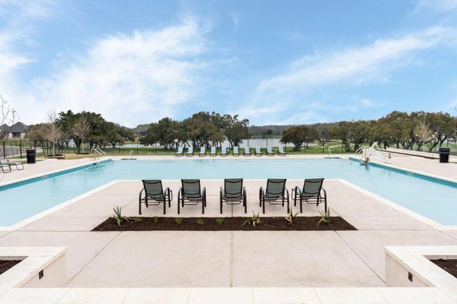Community pool with a patio area and fence | Image 16