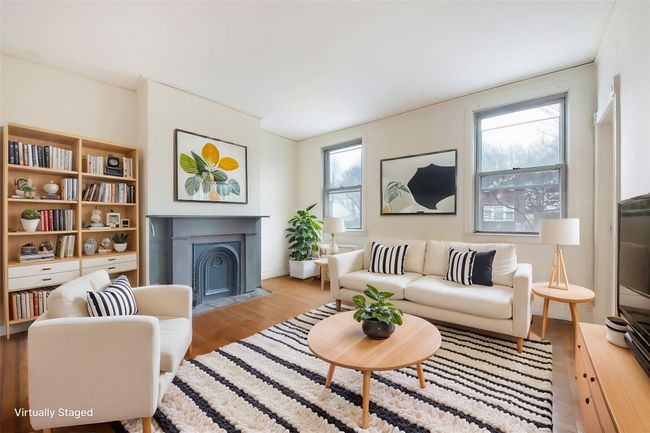Living room with light wood-type flooring and a fireplace with flush hearth | Image 7