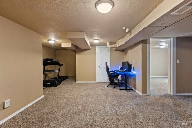 Office space with a textured ceiling and light carpet | Image 32