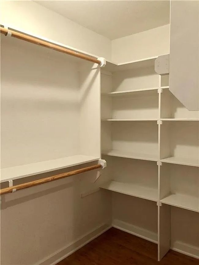 Walk in closet featuring wood finished floors | Image 9