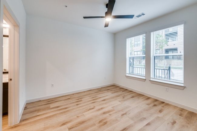 Spare room featuring light wood finished floors, visible vents, a ceiling fan, and baseboards | Image 19
