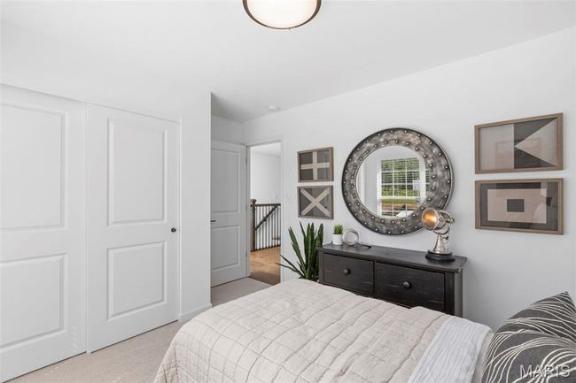 Carpeted bedroom with a closet | Image 8