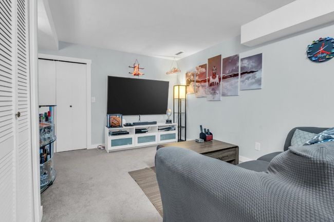 Carpeted living room with baseboards | Image 25