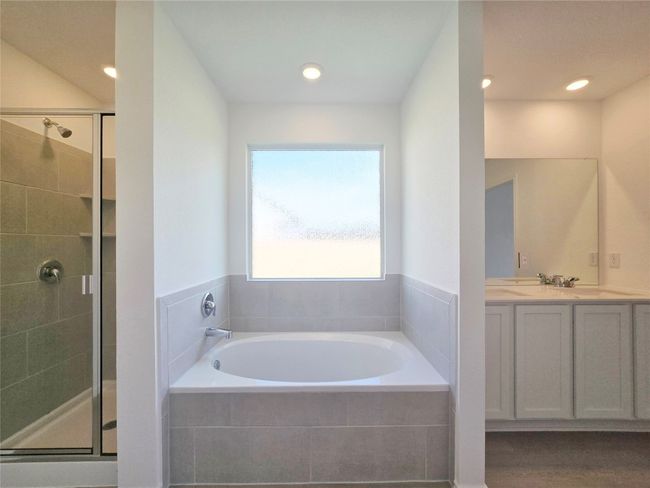 Full bathroom featuring vanity, a bath, a stall shower, and recessed lighting | Image 14