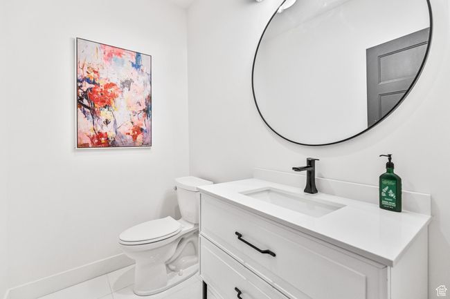 Bathroom featuring tile patterned flooring, vanity, baseboards, and toilet | Image 43