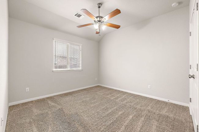 Empty room with carpet floors, a ceiling fan, visible vents, and baseboards | Image 22