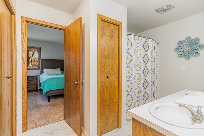 The full bathroom has abundant storage with two large closets and an additional linen closet. | Image 24