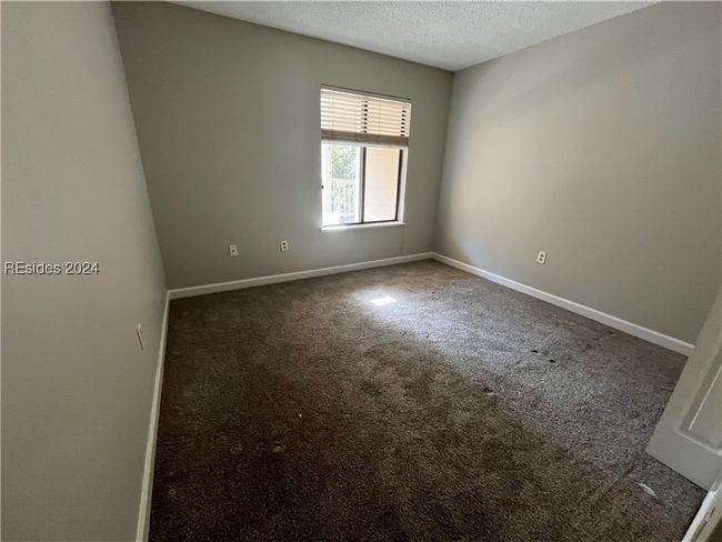 Carpeted spare room with a textured ceiling | Image 7