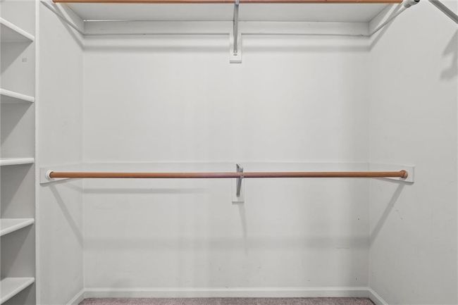 Walk in closet featuring carpet | Image 28