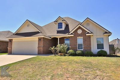 View of front facade featuring a front lawn and a garage | Image 2