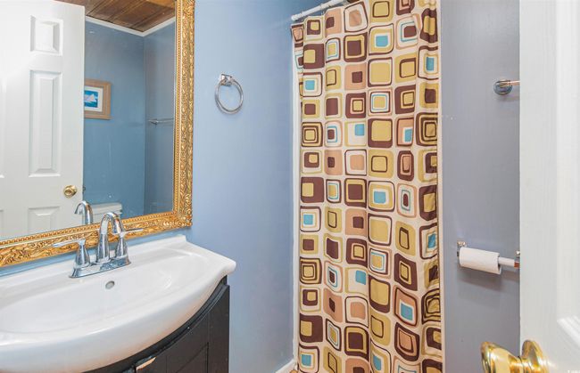 Bathroom with a shower with shower curtain and vanity | Image 33