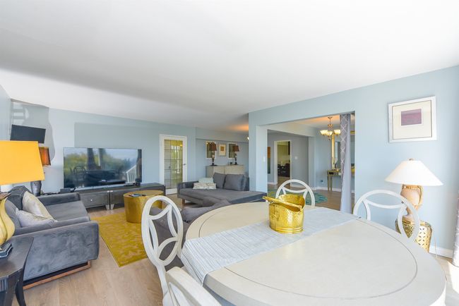 Dining area featuring a chandelier, light wood-type flooring, and baseboards | Image 9