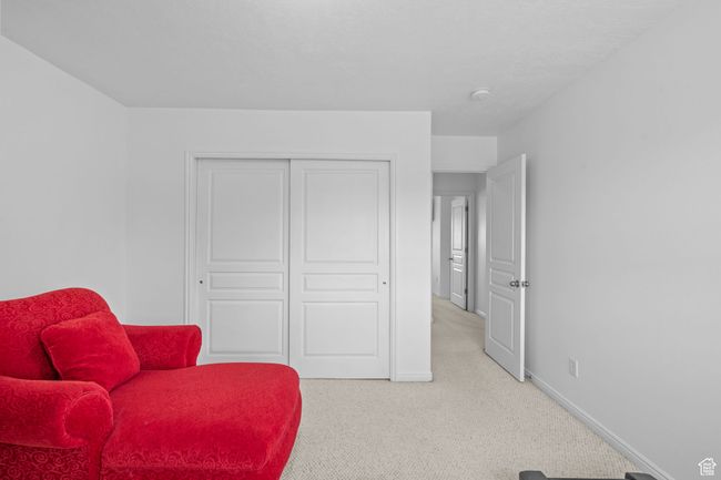 Sitting room featuring baseboards and light colored carpet | Image 30