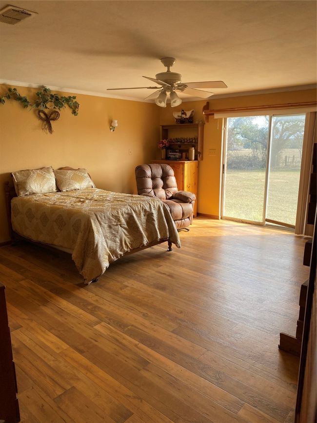 Bedroom with access to exterior, wood-style flooring, and ceiling fan | Image 21