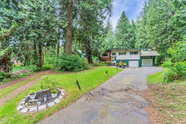 View of front of property featuring driveway, a front yard, and a garage | Image 9