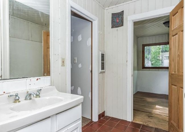 Bathroom with wood walls, vanity, toilet, and wood-type flooring | Image 19