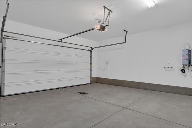 Garage with tankless water heater and a garage door opener | Image 5