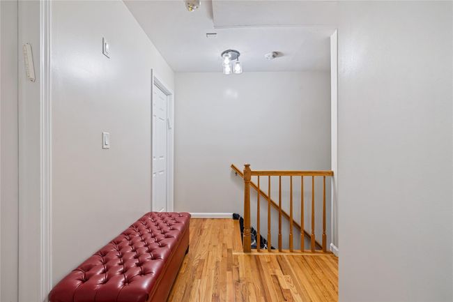 Hall with baseboards, an upstairs landing, and light wood-style floors | Image 28