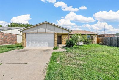 Single story home featuring a garage and a front lawn | Image 1