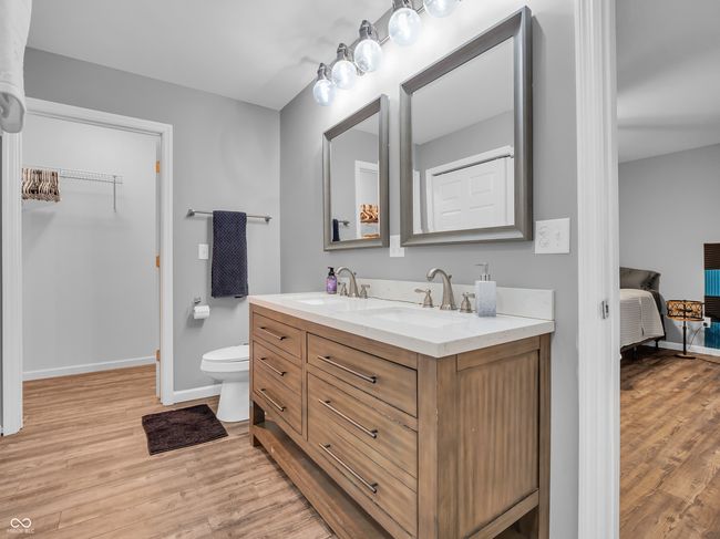 full bathroom featuring double vanity, walk-in closet | Image 13
