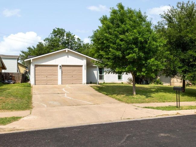 View of front of property with an attached garage, driveway, and brick siding | Image 14
