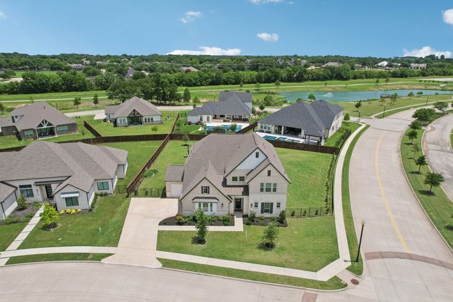 Aerial view of residential area featuring a nearby body of water and a tree filled landscape | Image 32
