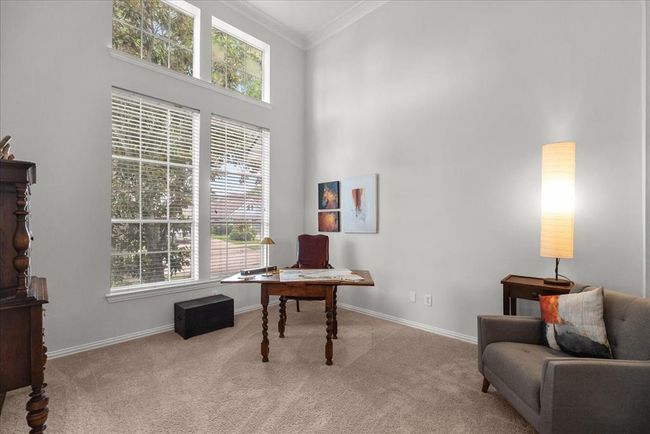 This space offers a bright and inviting area with high ceilings and large windows for ample natural light, making it ideal for a home office or study. | Image 15