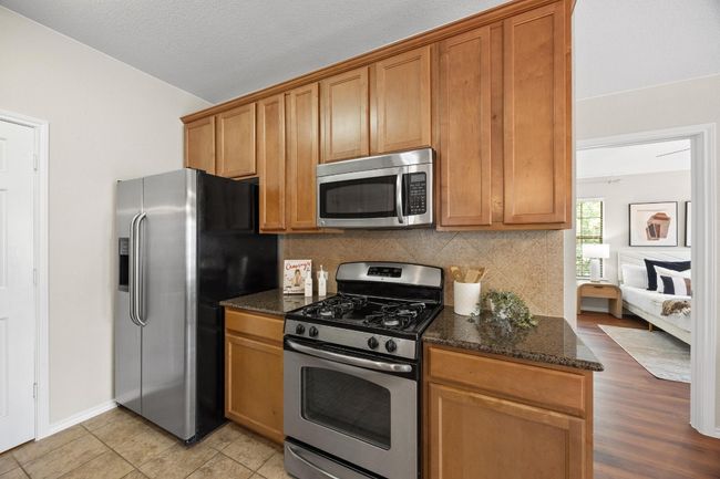 Kitchen with stainless steel appliances, granite counter tops | Image 12