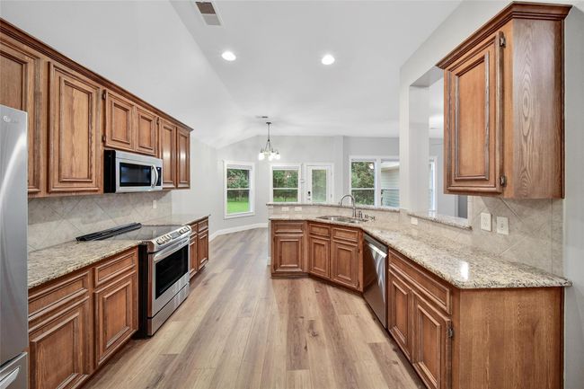 Great counter space and loads of storage including a walk-in pantry make this kitchen easy to work in. | Image 12