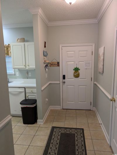 Tiled entryway featuring ornamental molding and a textured ceiling | Image 3