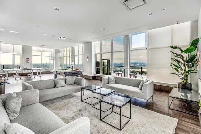 Living room with plenty of natural light, expansive windows, and wood finished floors | Image 25